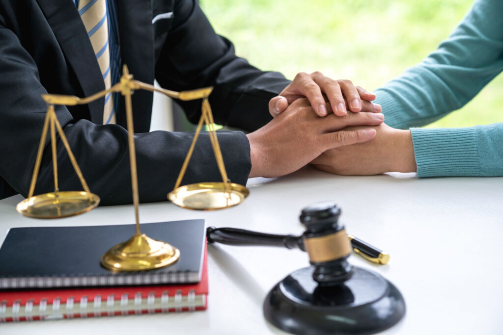 lawyer comforts client with hands on top 2026 03 19 01 52 07 utc